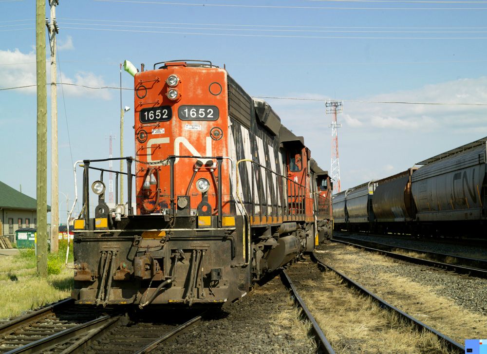 Locomotives wait for a passing freight train, Alberta. 